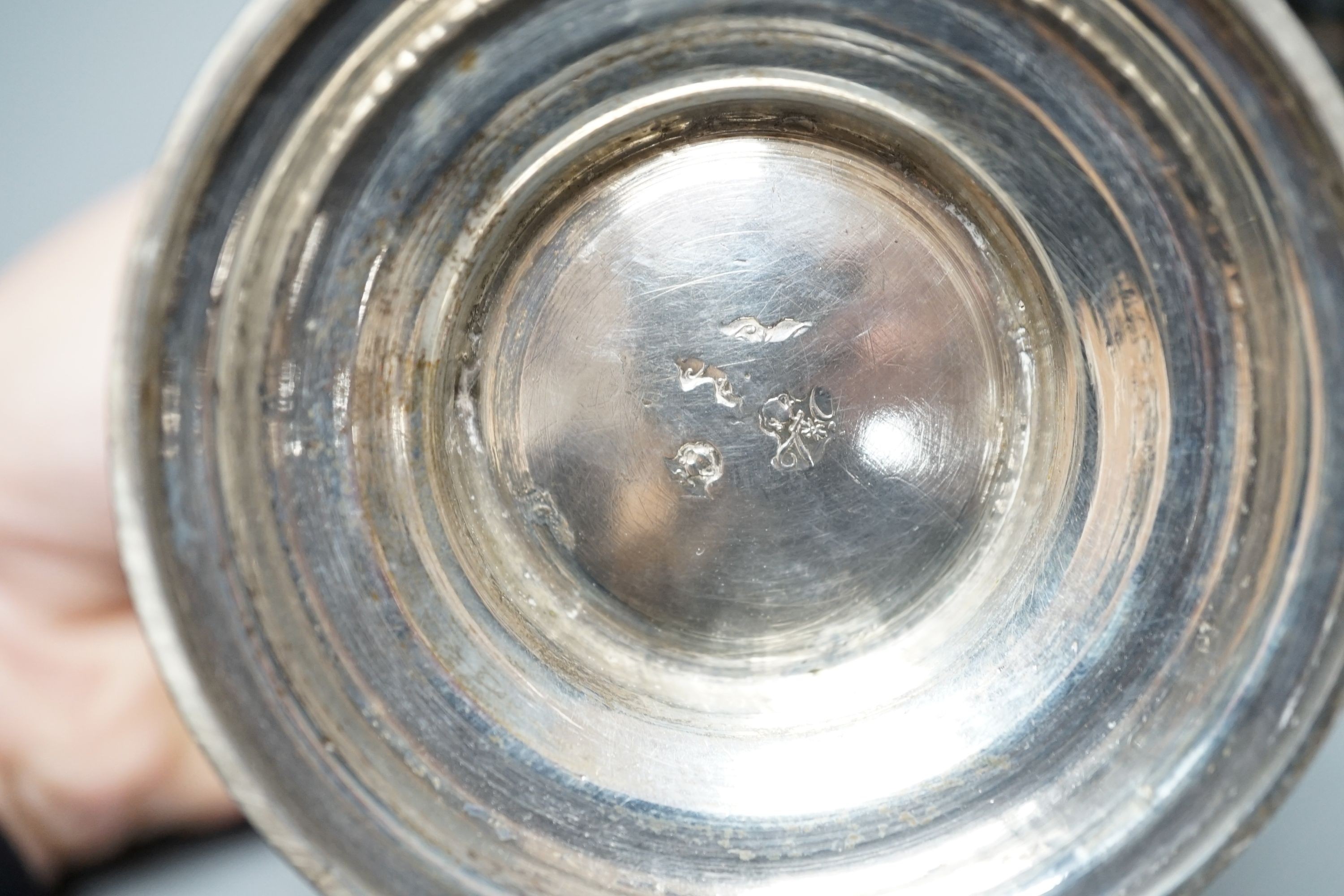 An Edwardian silver bowl, embossed with putto amid scrolls, London, 1902, diameter 13.1cm and a white metal bowl and cover, gross 20.5oz.